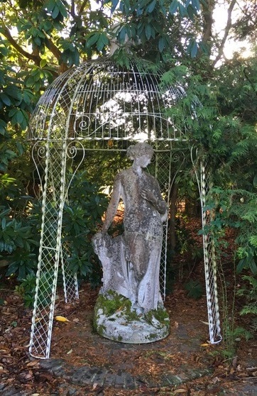 A white painted wrought iron gazebo